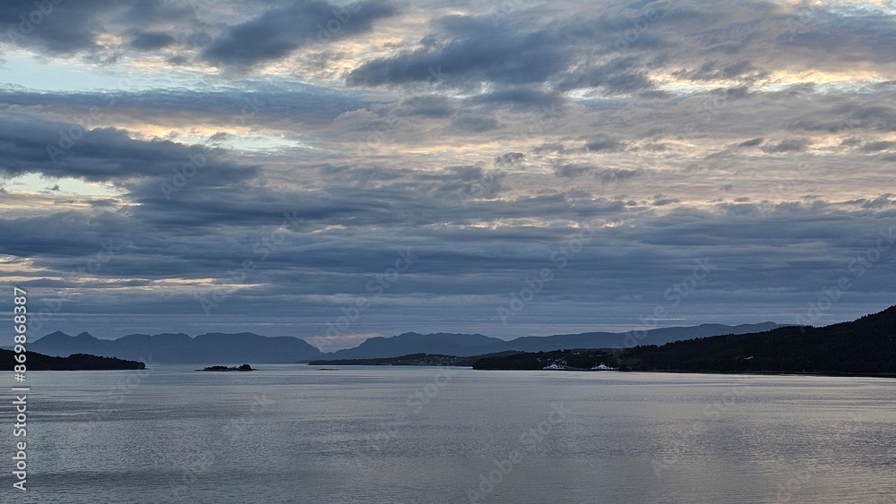 White nights in the fjords of Norway. Horizon and ferry crossing. Sky and clouds.