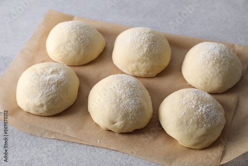 Raw dough balls on light grey table