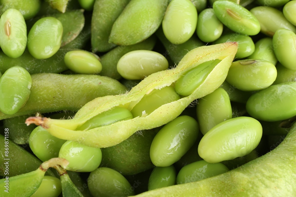 Raw green edamame soybeans and pods as background, closeup Raw green edamame soybeans and pods as background, closeup
