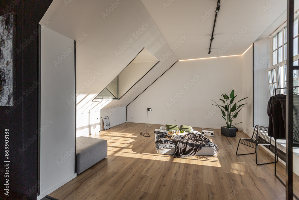 Fototapeta premium minimalist stylish interior of white simple bedroom with window in ceiling and sun rays without people
