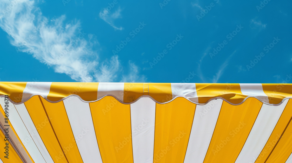 Fototapeta premium Yellow sun umbrella standing on a beach, heatwave.
