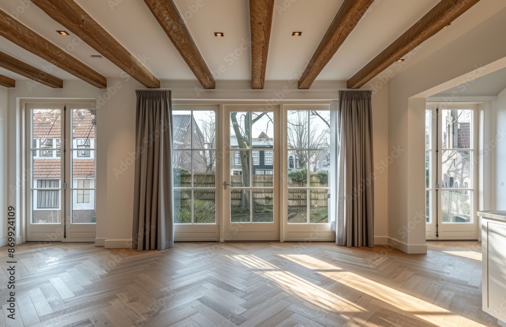 Fototapeta premium Spacious empty living room with large windows and exposed wooden beams