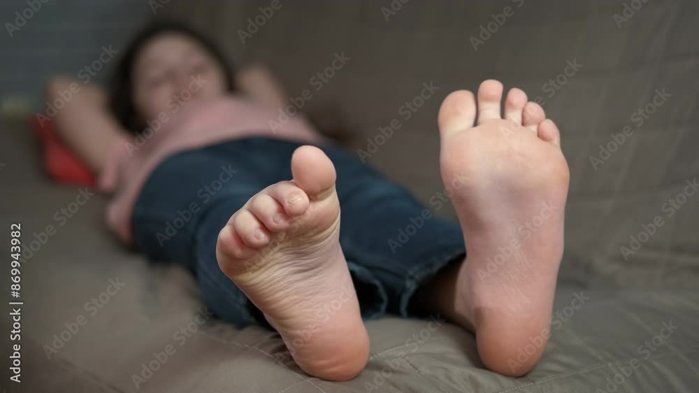 Teen enjoy relaxation with bare feet. A teen enjoy girl the relaxation on the sofa with bare feet.