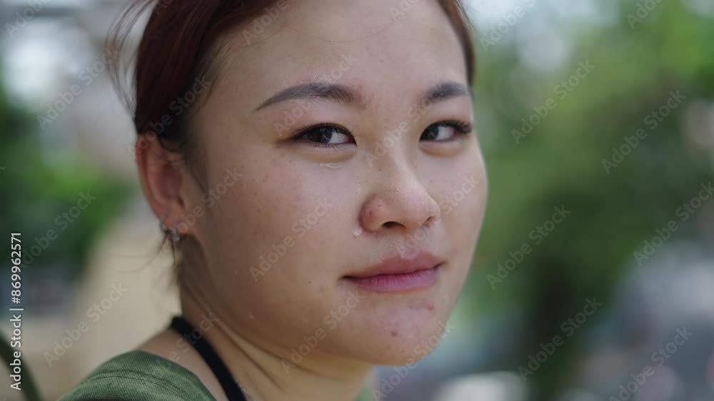 portrait of a young girl looking blinking and smiling at camera with wet face portrait of a young girl looking blinking and smiling at camera with wet face
