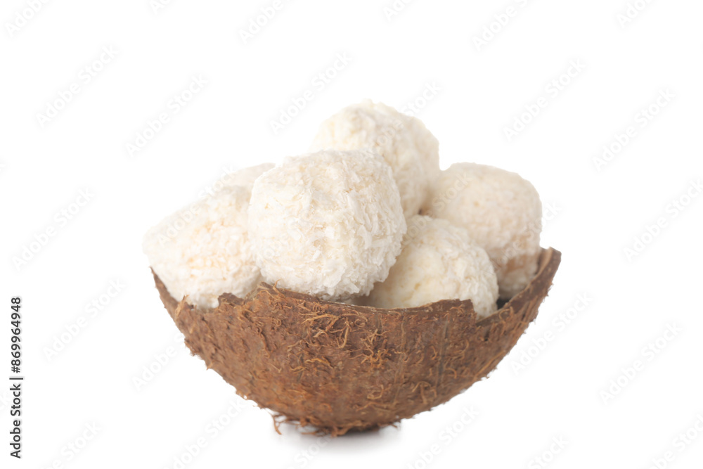 Coconut shell with delicious chocolate candies isolated on white background Coconut shell with delicious chocolate candies isolated on white background