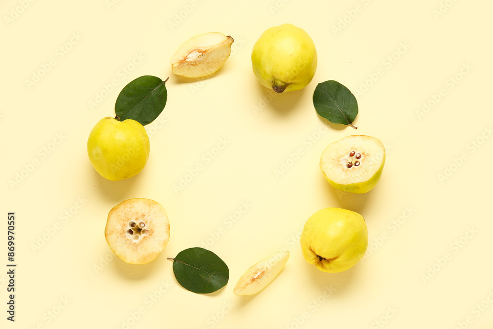 Frame made of sweet ripe quinces and leaves on yellow background Frame made of sweet ripe quinces and leaves on yellow background