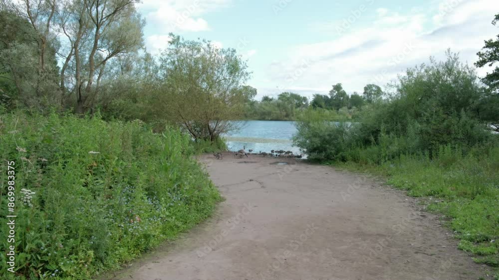 EDINBURGH - JUNE 24, 2024: A view of the path leading to Duddingston Loch in Edinburgh, Scotland. EDINBURGH - JUNE 24, 2024: A view of the path leading to Duddingston Loch in Edinburgh, Scotland.