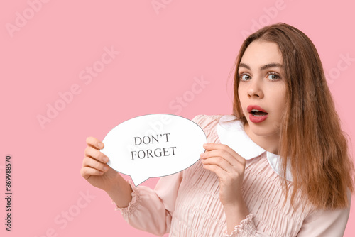 Excited young woman holding...