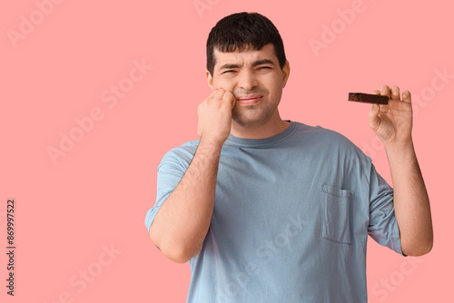 Young man with candy bar su...