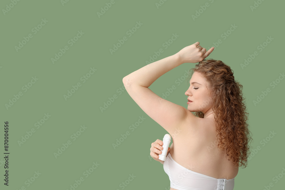 Beautiful young woman applying deodorant on green background Beautiful young woman applying deodorant on green background