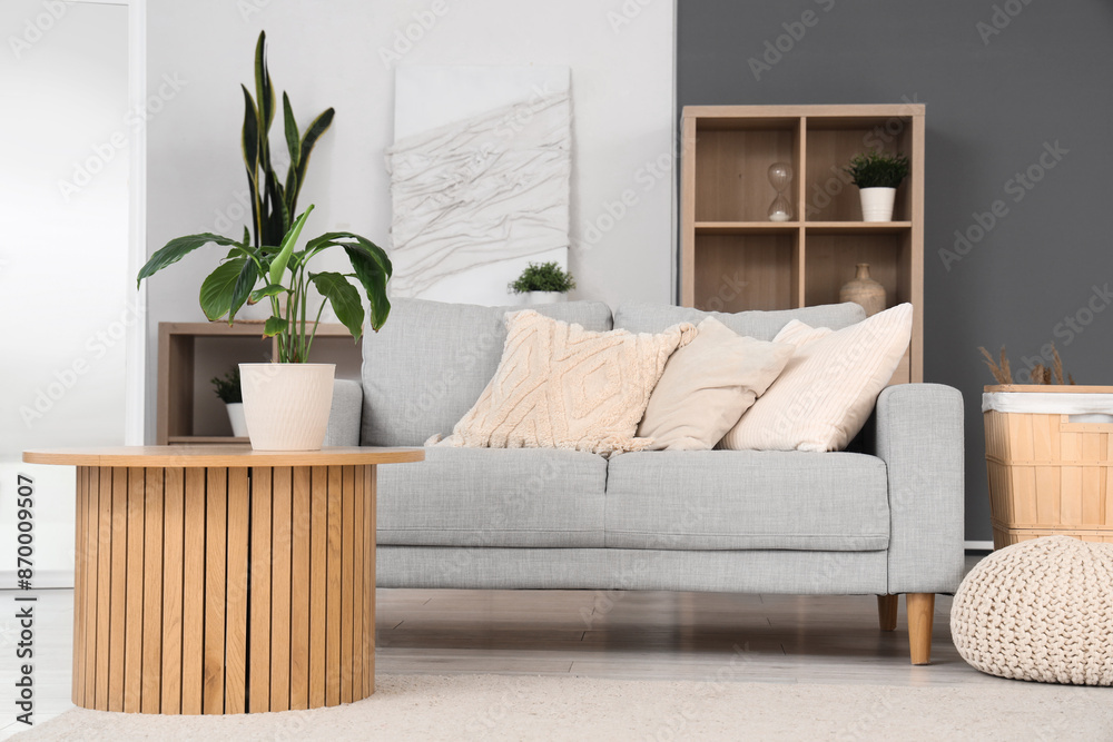 Interior of modern living room with sofa, table and plant
