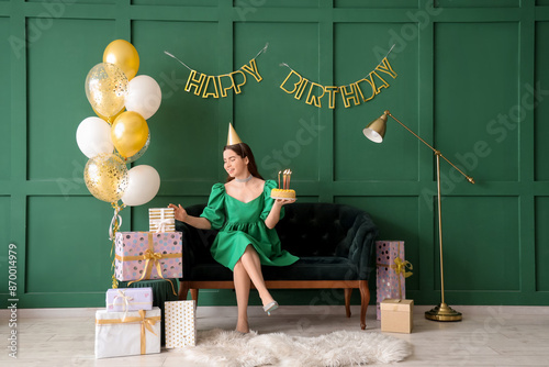 Young woman in party hat wi...