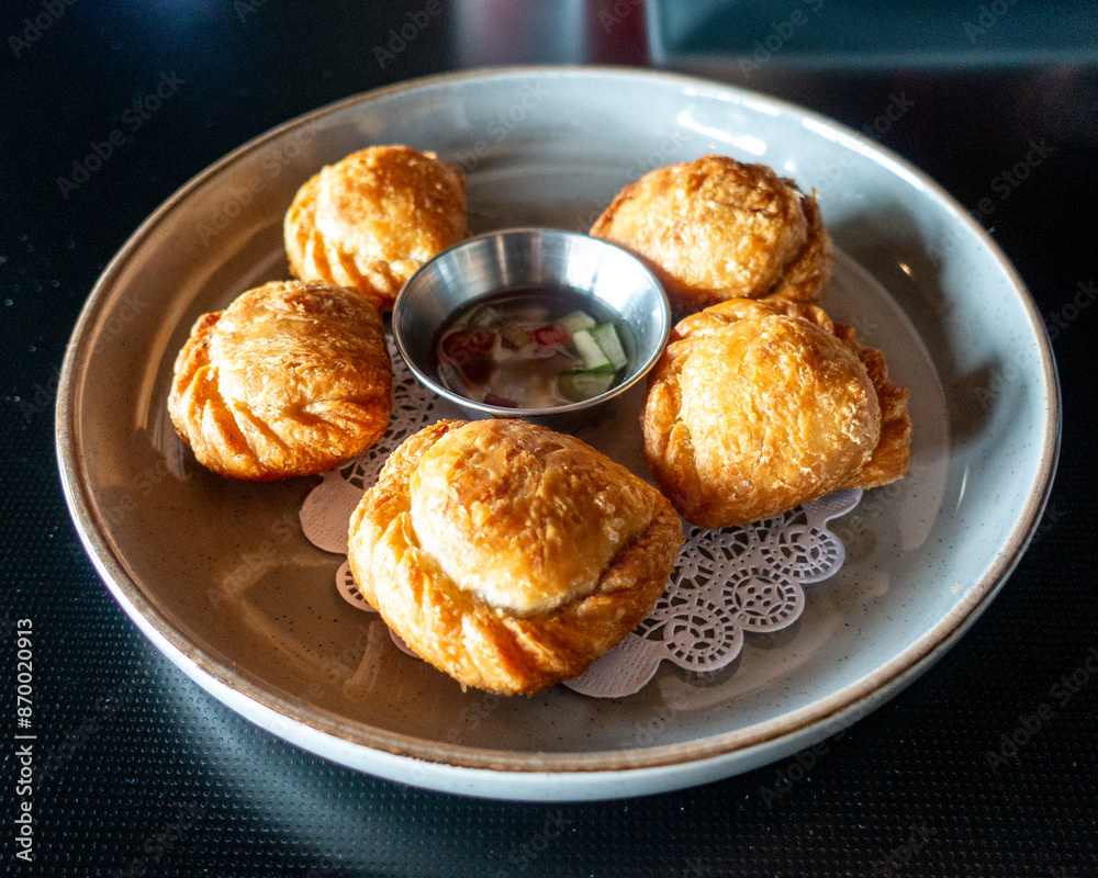 Golden-brown pastry parcels filled with spiced potatoes, peas, and tender chicken, baked to crispy perfection. Bursting with aromatic curry flavors, a delightful fusion snack for any occasion