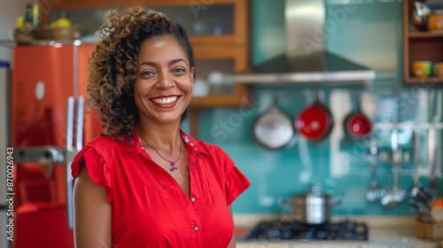 portrait of a latina housewife standing at her home kitchen, natural light background, woman, smiling red clothes, ideal usage for social media or consumer concepts, cozinha brasileira, dona de casa, 