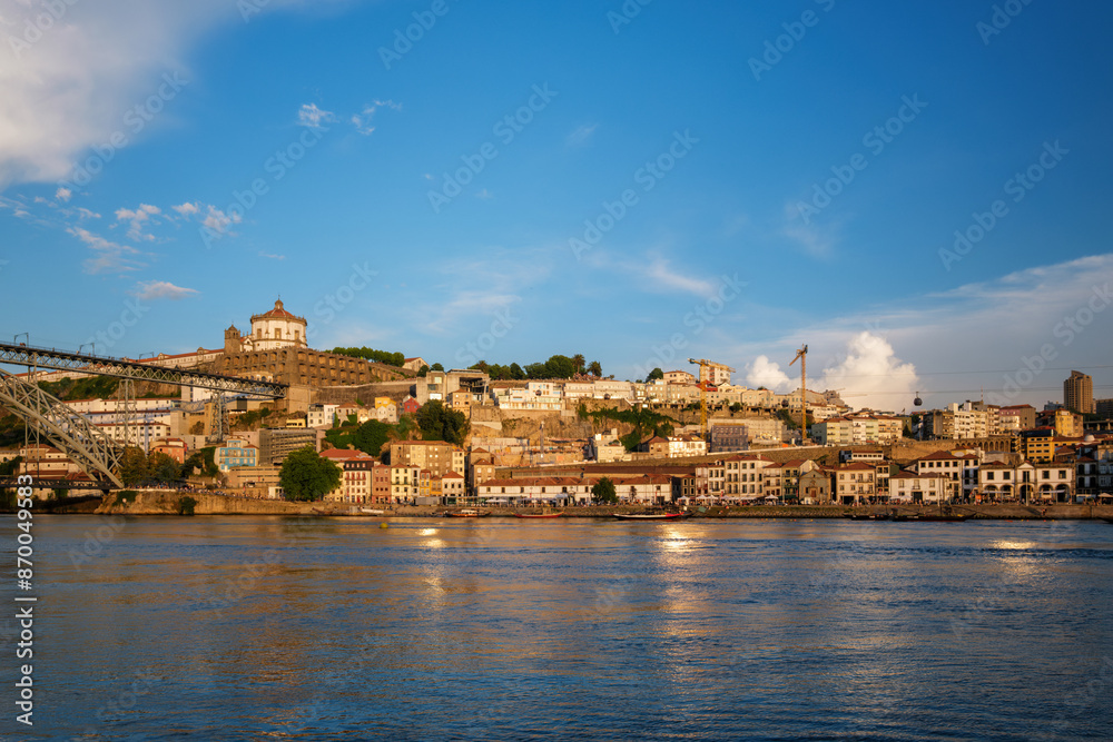 Naklejka premium View of Vila Nova de Gaia city riverfront with Mosteiro da Serra do Pilar monastery and Dom Luis I bridge over Douro river on sunset. Porto, Vila Nova de Gaia, Portugal