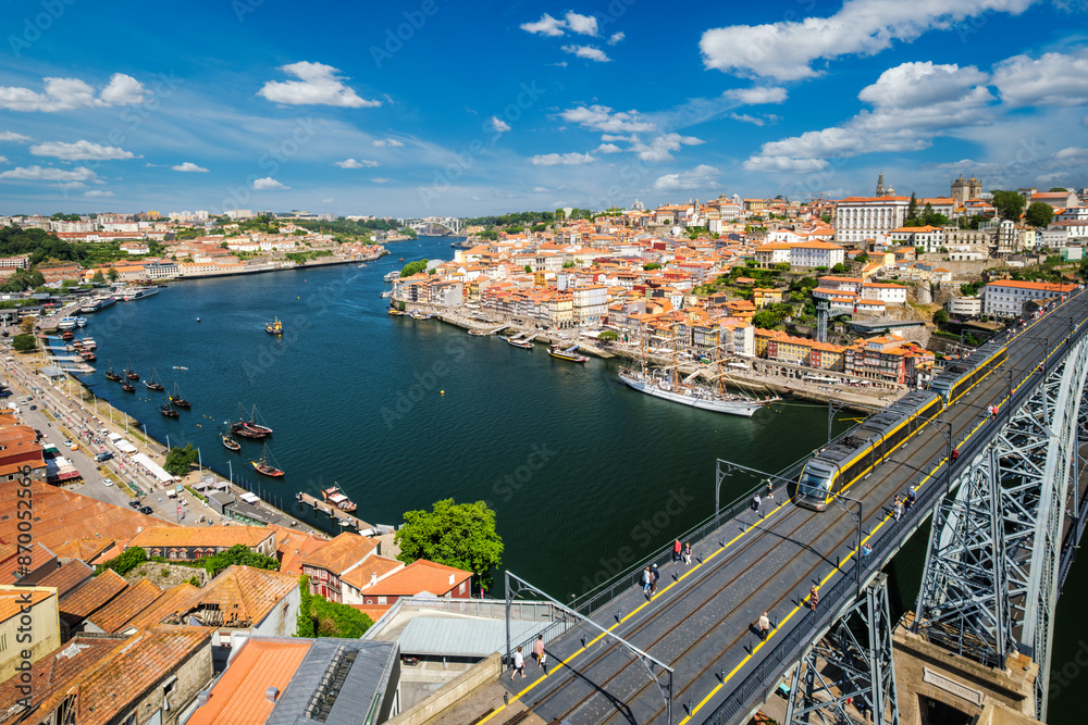 View of Porto city and Douro river with moored sailing ship and Dom Luis bridge I from famous tourist viewpoint Miradouro da Serra do Pilar on sunset. Porto, Vila Nova de Gaia, Portugal View of Porto city and Douro river with moored sailing ship and Dom Luis bridge I from famous tourist viewpoint Miradouro da Serra do Pilar on sunset. Porto, Vila Nova de Gaia, Portugal