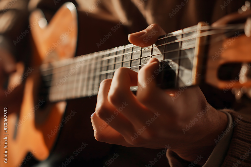Fototapeta premium Close-Up of Guitarist Fingers Strumming Acoustic Guitar