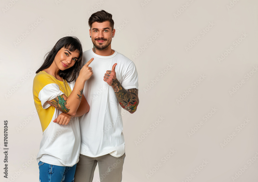 Happy hispanic young couple standing and pointing aside at copy space, they have tattoos. Happy hispanic young couple standing and pointing aside at copy space, they have tattoos.