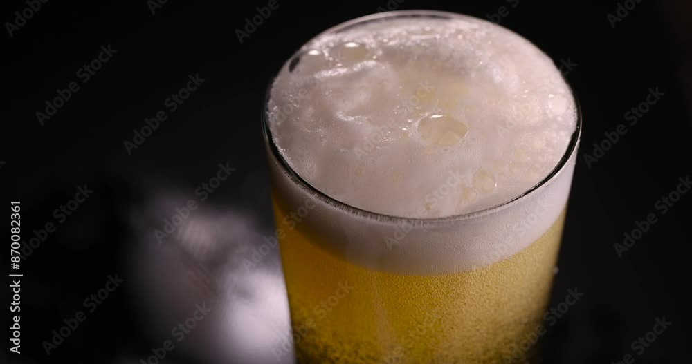 light golden beer in a glass glass on a black background, alcoholic drink beer in a glass glass light golden beer in a glass glass on a black background, alcoholic drink beer in a glass glass