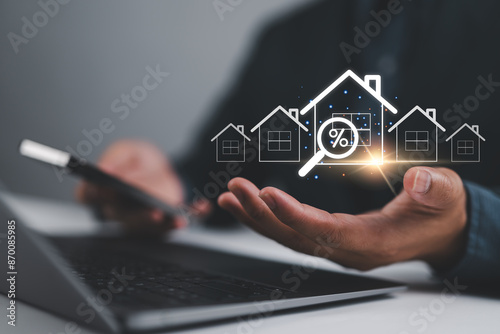 Real estate investment concept, Businessman use laptop with house icon for analyzing mortgage loan home and insurance real property mortgage. interest rate, Investment planning, business real estate. photo