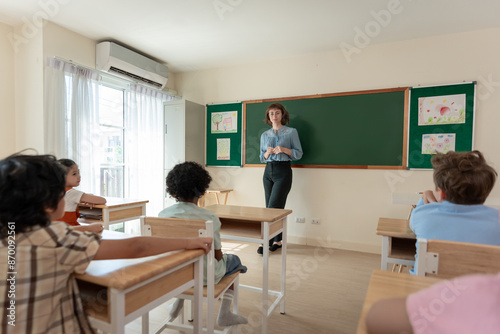 Caucasian young woman teacher teaching student in classroom at school.