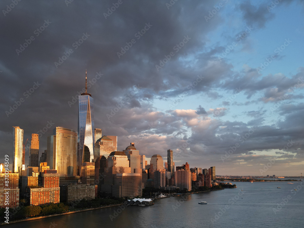 Obraz premium New York City top view. NYC aerial view, New York City Skyline with dramatic sky. Panoramic drone view on Manhattan in NY. Sunset in NYC. New York City Midtown skyline view at dusk with clouds.