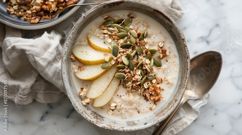 A cozy and comforting bowl of buckwheat cereal combined with warm vanillainfused almond milk diced pear and a sprinkle of pumpkin seeds. photo