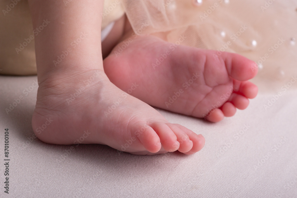 Little newborn baby human feet with toes and toenails close up