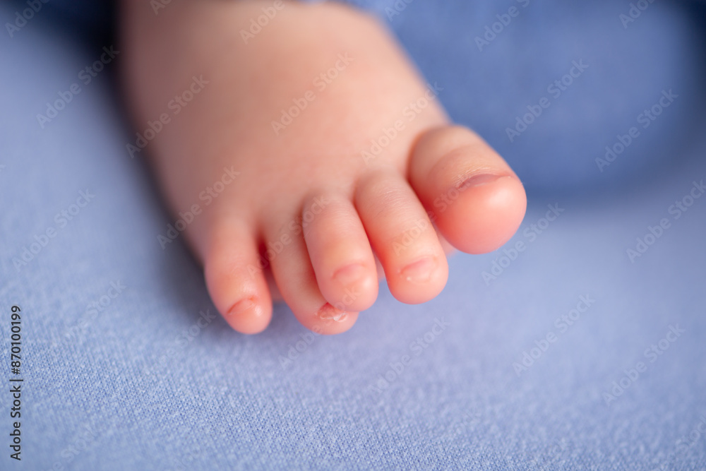 Little newborn baby human feet with toes and toenails close up Little newborn baby human feet with toes and toenails close up