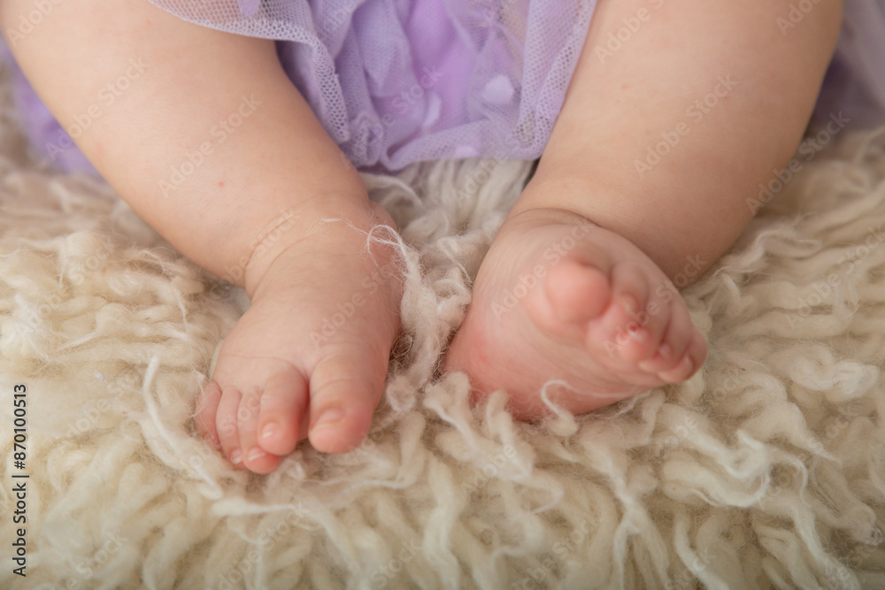 Little newborn baby human feet with toes and toenails close up Little newborn baby human feet with toes and toenails close up