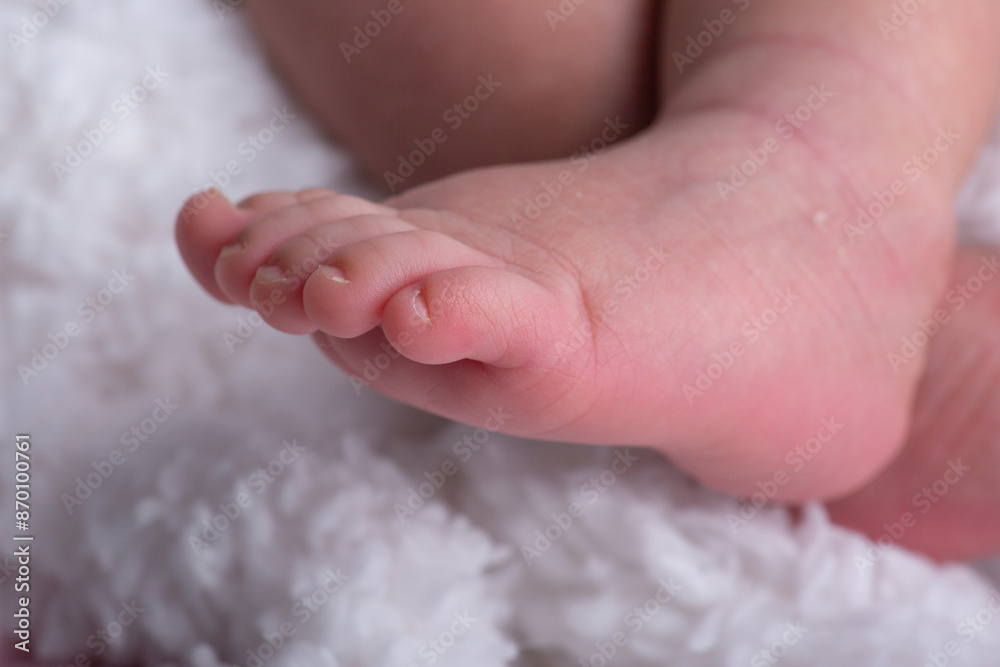 Little newborn baby human feet with toes and toenails close up Little newborn baby human feet with toes and toenails close up