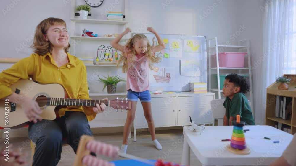 Caucasian young woman teacher playing guitar with students in school. Caucasian young woman teacher playing guitar with students in school.