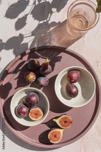 Fresh Figs on a Pink Tray With a Glass of Water and Sunlight
