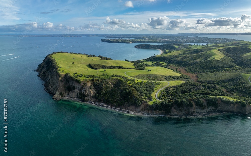 Obraz premium Headland and farmland in Shakespeare Regional Park. Army Bay, Whangaparāoa, Auckland, New Zealand.