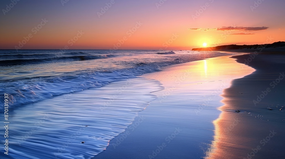 A calm beach at sunset with gentle waves, illustrating the end of a day and reflection. A calm beach at sunset with gentle waves, illustrating the end of a day and reflection.