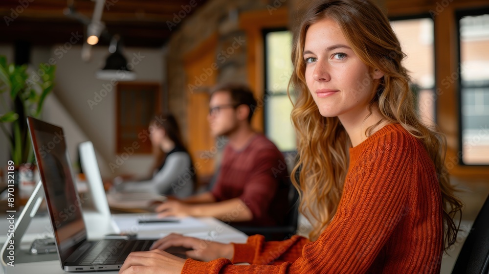 Young Professionals Working in a Modern Office Space with Natural Light and Wooden Interiors Young Professionals Working in a Modern Office Space with Natural Light and Wooden Interiors