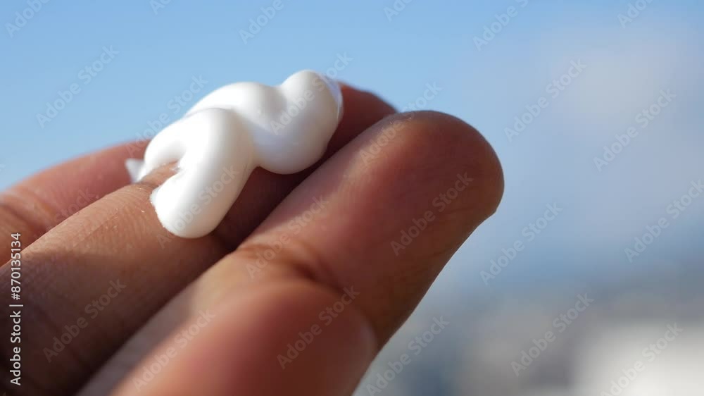 Close up of person hand using sunscreen cream outdoor Close up of person hand using sunscreen cream outdoor