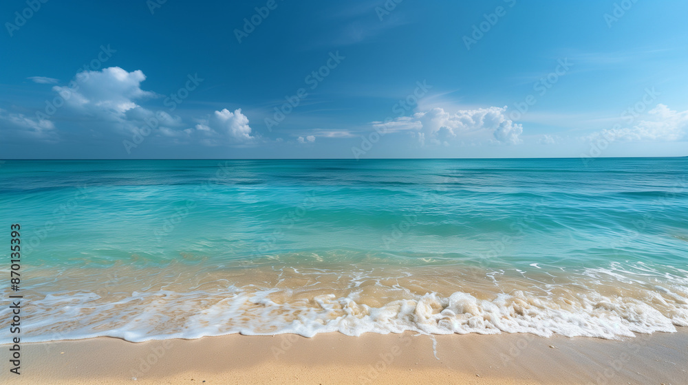 Sandy beach meets the clear blue ocean under a bright sky. Sandy beach meets the clear blue ocean under a bright sky.