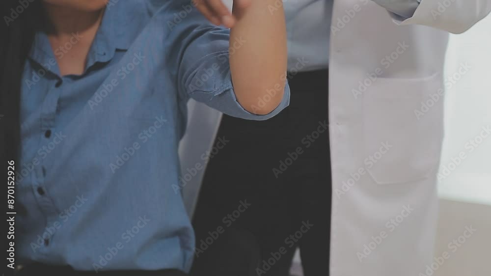 Doctor or Physiotherapist working examining treating injured arm of athlete male patient, stretching and exercise, Doing the Rehabilitation therapy pain in clinic. Doctor or Physiotherapist working examining treating injured arm of athlete male patient, stretching and exercise, Doing the Rehabilitation therapy pain in clinic.
