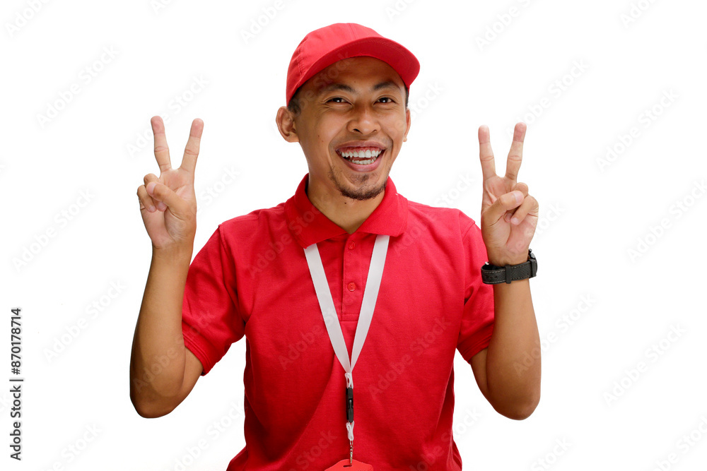 Attractive Asian delivery man or courier showing a peace gesture or V sign to the camera, isolated on a white background Attractive Asian delivery man or courier showing a peace gesture or V sign to the camera, isolated on a white background
