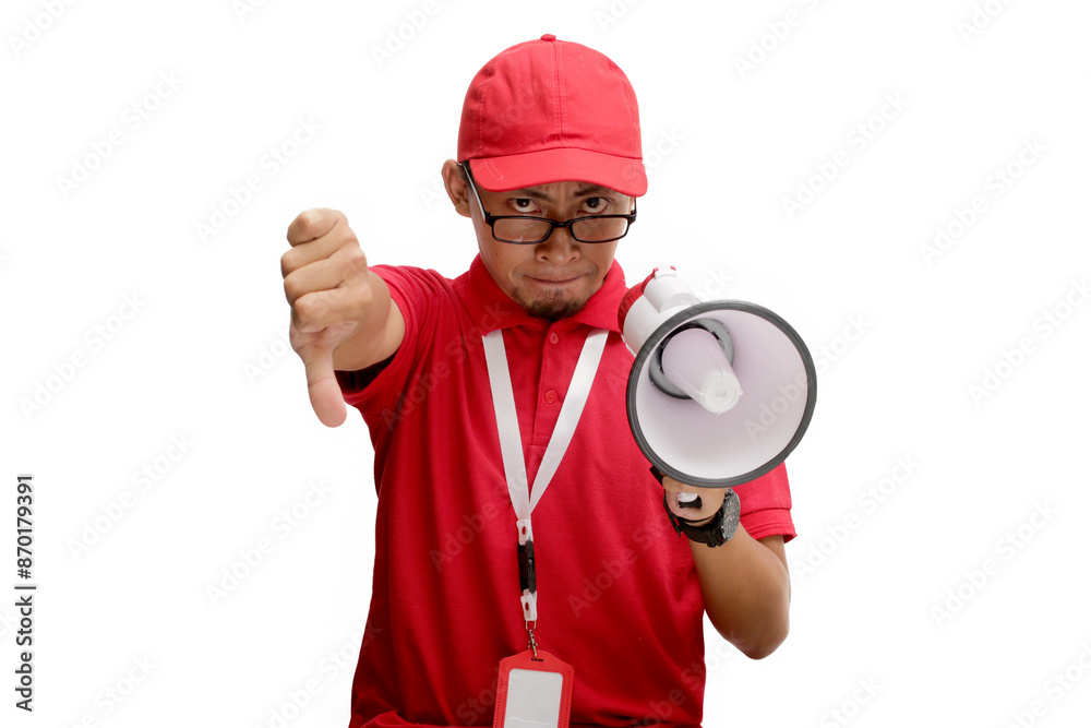 Dissatisfied Asian delivery man or courier giving a thumbs down gesture, indicating bad feedback or a low rating, while holding a megaphone. Isolated on a white background Dissatisfied Asian delivery man or courier giving a thumbs down gesture, indicating bad feedback or a low rating, while holding a megaphone. Isolated on a white background