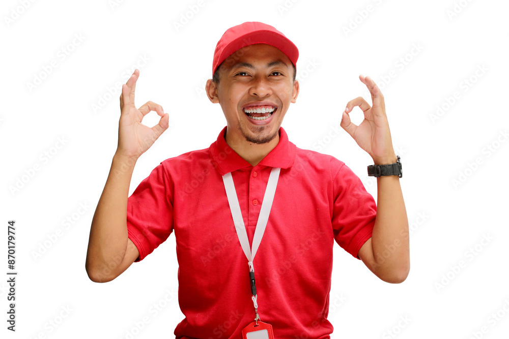 Excited Asian delivery man or courier showing an OK gesture at the camera, expressing satisfaction, approval, giving a good review, high rating, or positive feedback, isolated on a white background Excited Asian delivery man or courier showing an OK gesture at the camera, expressing satisfaction, approval, giving a good review, high rating, or positive feedback, isolated on a white background