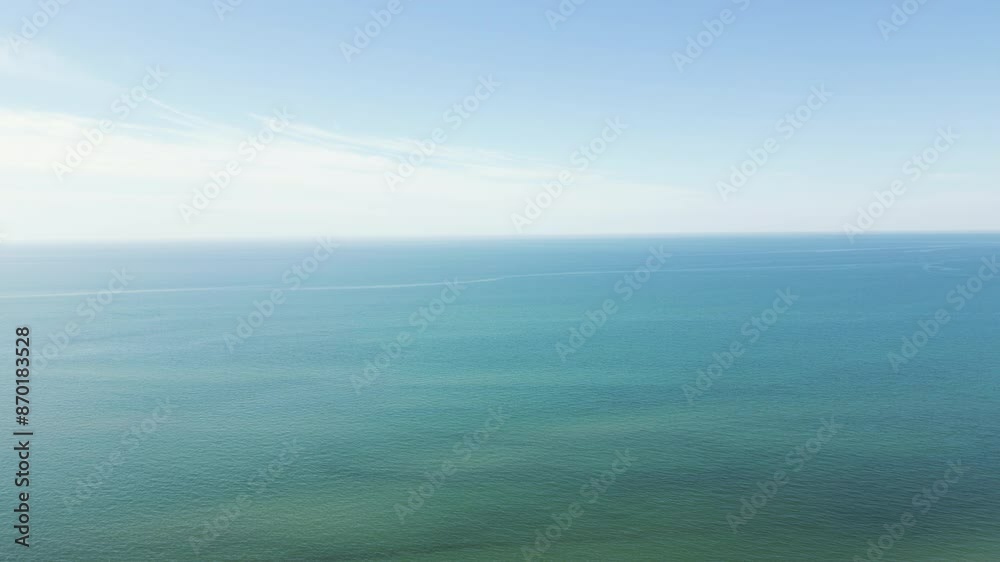 Tranquil blue ocean water with soft white glow in sky, calm peaceful nature background Tranquil blue ocean water with soft white glow in sky, calm peaceful nature background