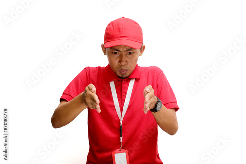 Asian delivery man is gesturing a small size with his finger, indicating something not very big, demonstrate tiny size gesture. Insecurity and lack of confidence concept. Isolated on white background photo