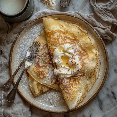 Stacked Golden Brown Crepes With Powdered Sugar on a Rustic Wooden Table