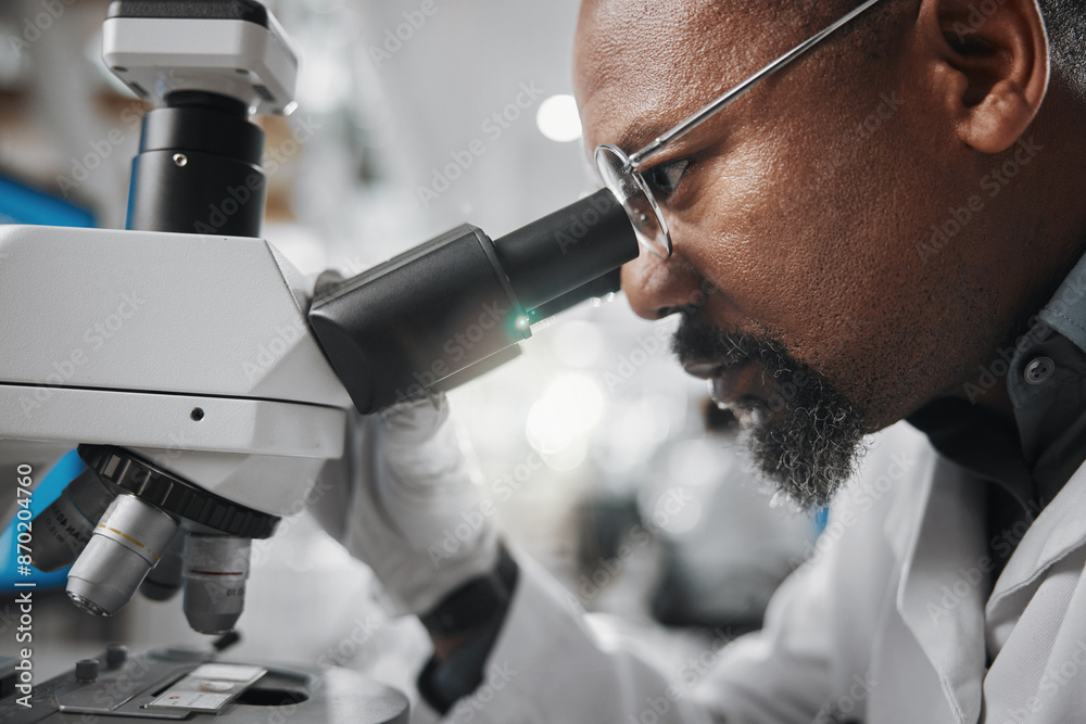 Black man, healthcare and microscope in laboratory for analysis, innovation and medical research. Development, technology and professional person or scientist in clinic for diagnosis and cure Black man, healthcare and microscope in laboratory for analysis, innovation and medical research. Development, technology and professional person or scientist in clinic for diagnosis and cure