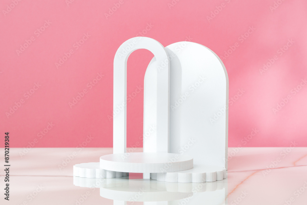 Decorative podiums against pink background in studio Decorative podiums against pink background in studio
