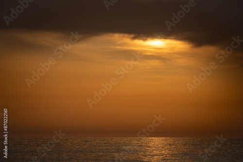 Sunset on the sea coast. Seascape orange sunset.