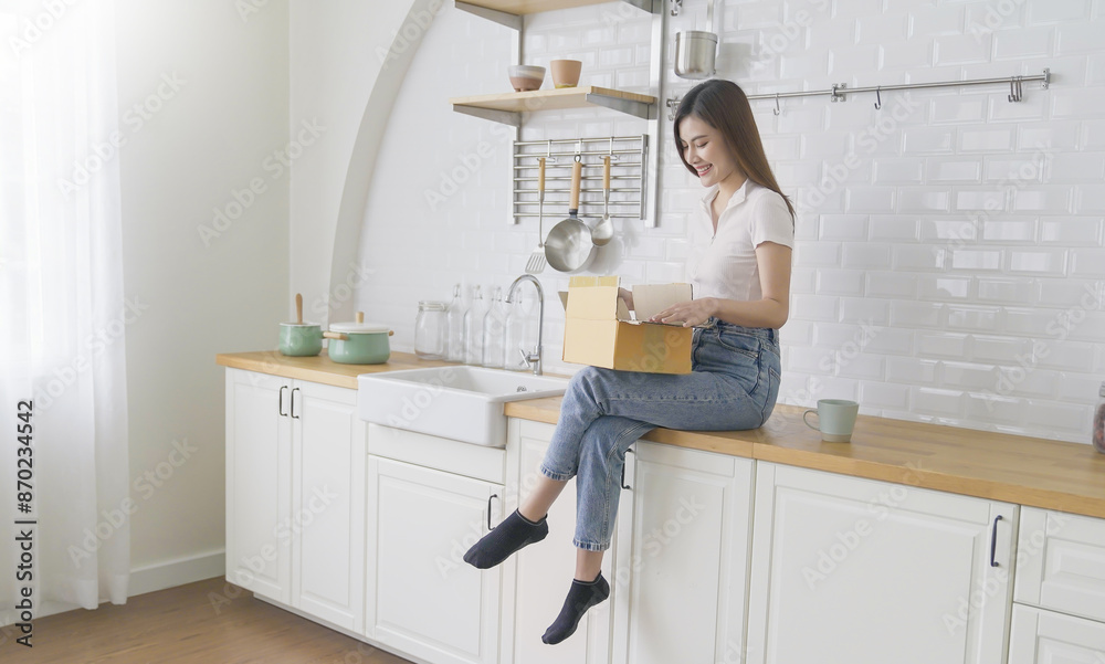 Asian woman sit on couch at home opening carton box received parcel package from relatives or shopper make order internet website satisfied client, easy and fast service commerce delivery concept Asian woman sit on couch at home opening carton box received parcel package from relatives or shopper make order internet website satisfied client, easy and fast service commerce delivery concept