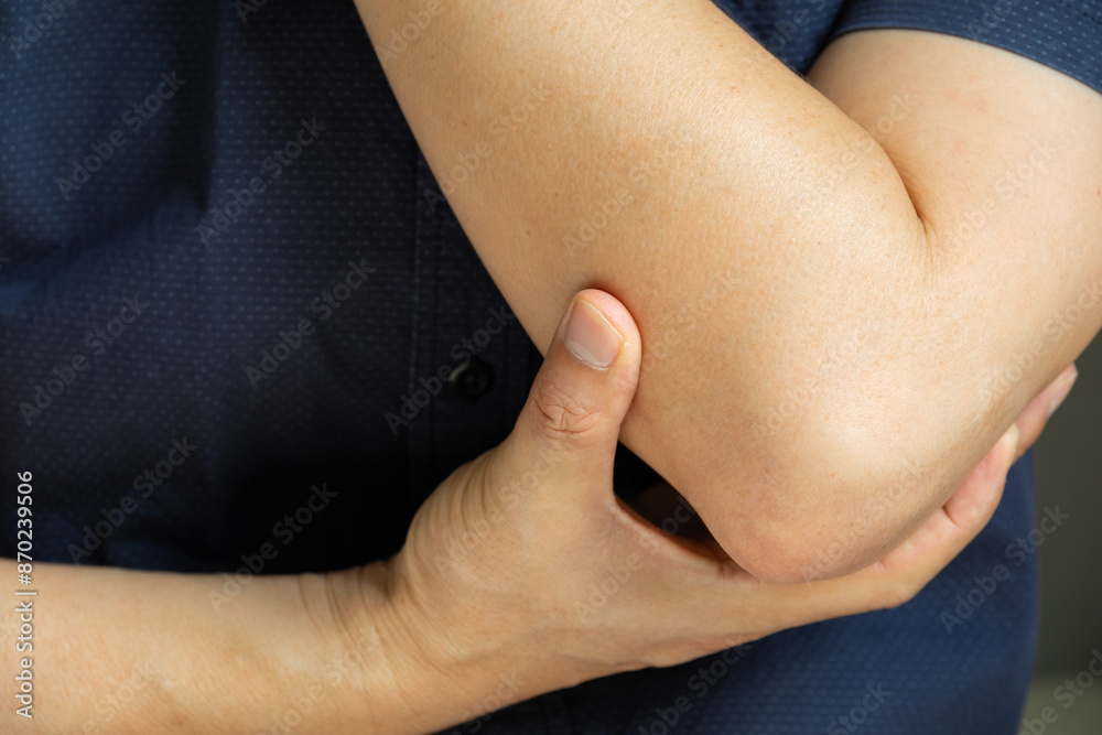 man has pain in his elbow and tendon muscles and he relieves the pain with a massage. Health and healing concept man has pain in his elbow and tendon muscles and he relieves the pain with a massage. Health and healing concept